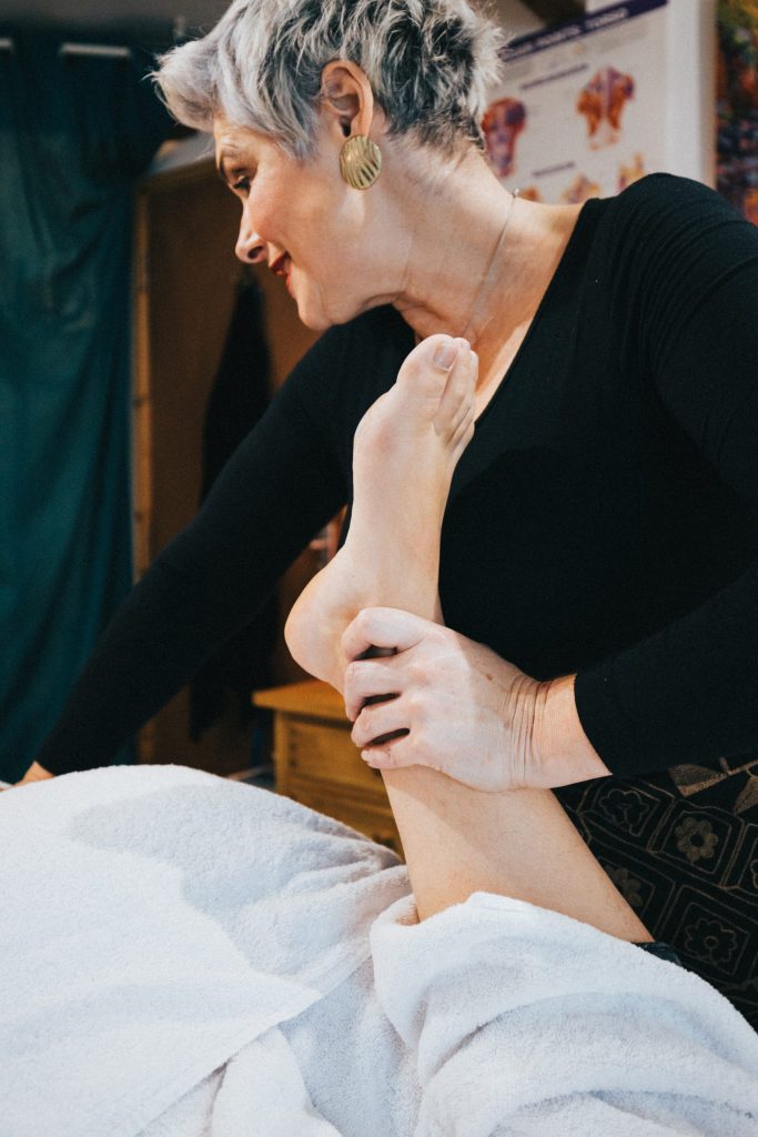 a picture of dawn symons giving a sports massage